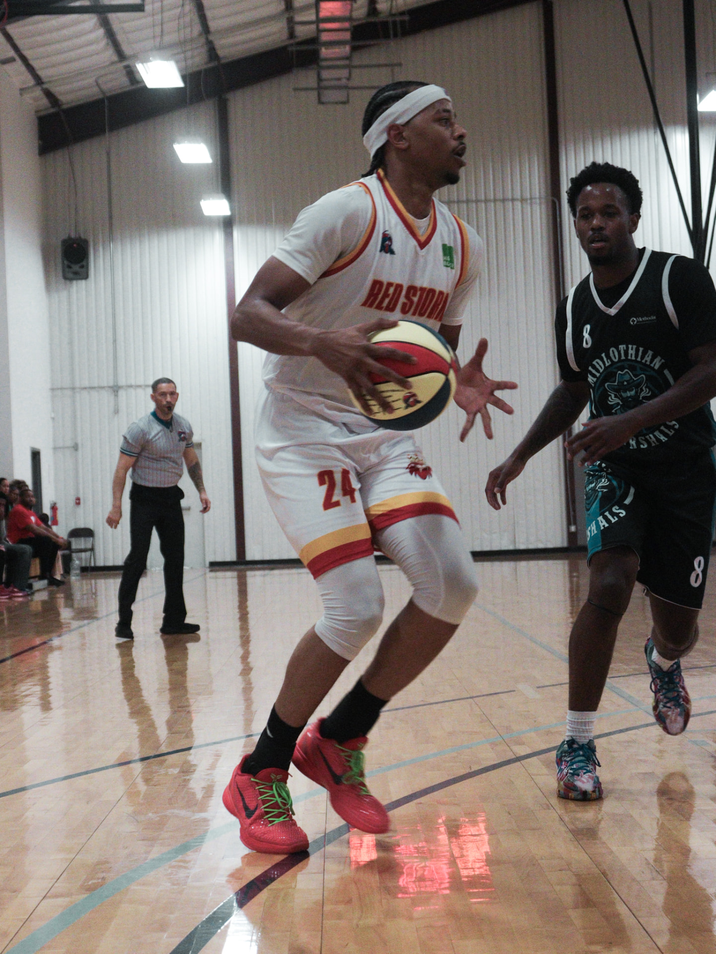 Redstorm player in a white number 24 basketball jersey with red and gold accents during a game