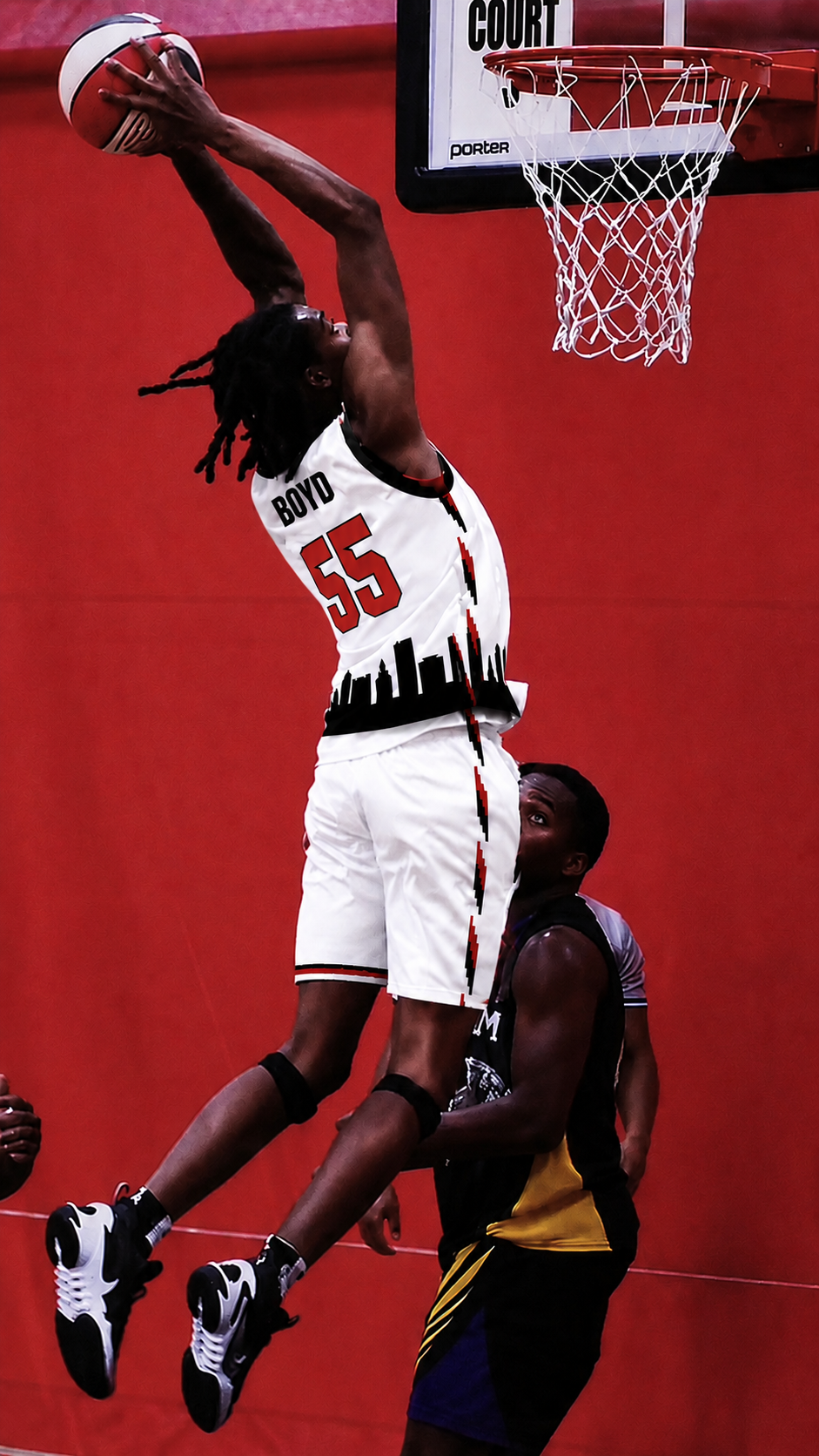 Player dunking in a white number 55 basketball jersey with red lettering and a black skyline design